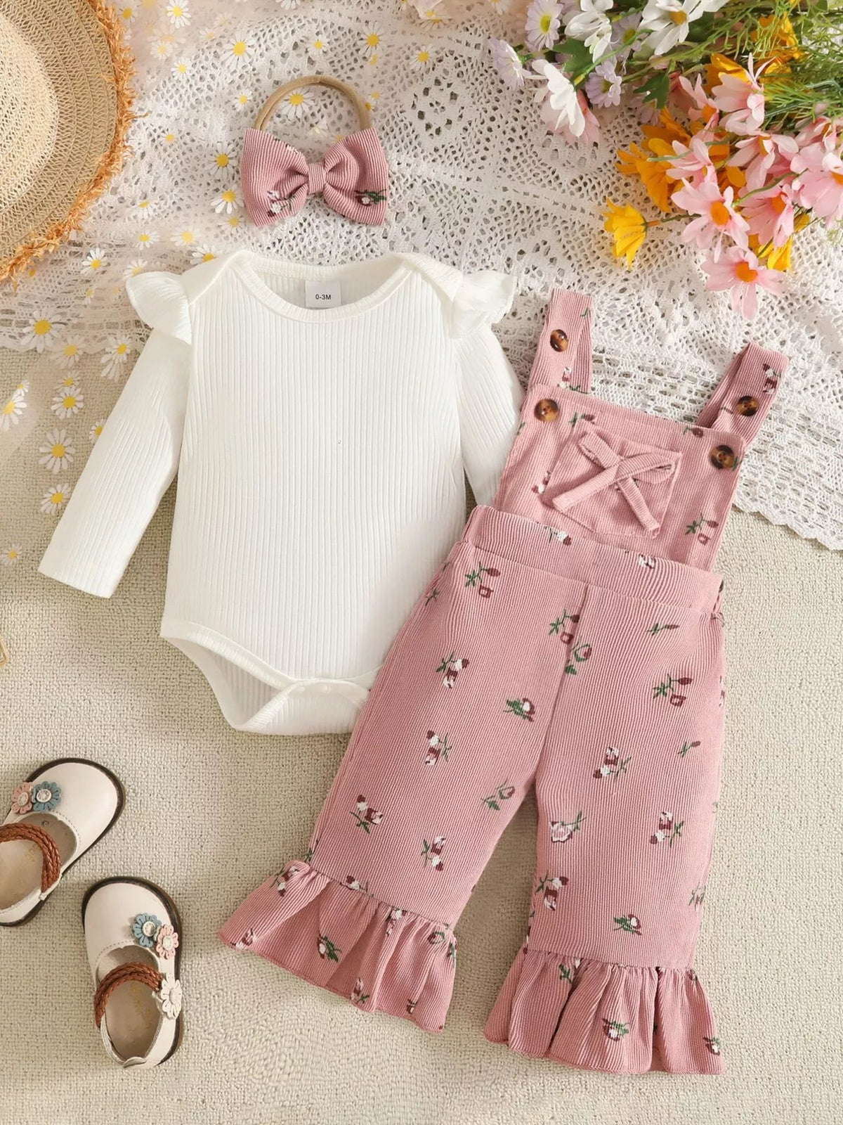 White bodysuit and floral ribbed overalls with bow headband — white bodysuit beside pink overalls