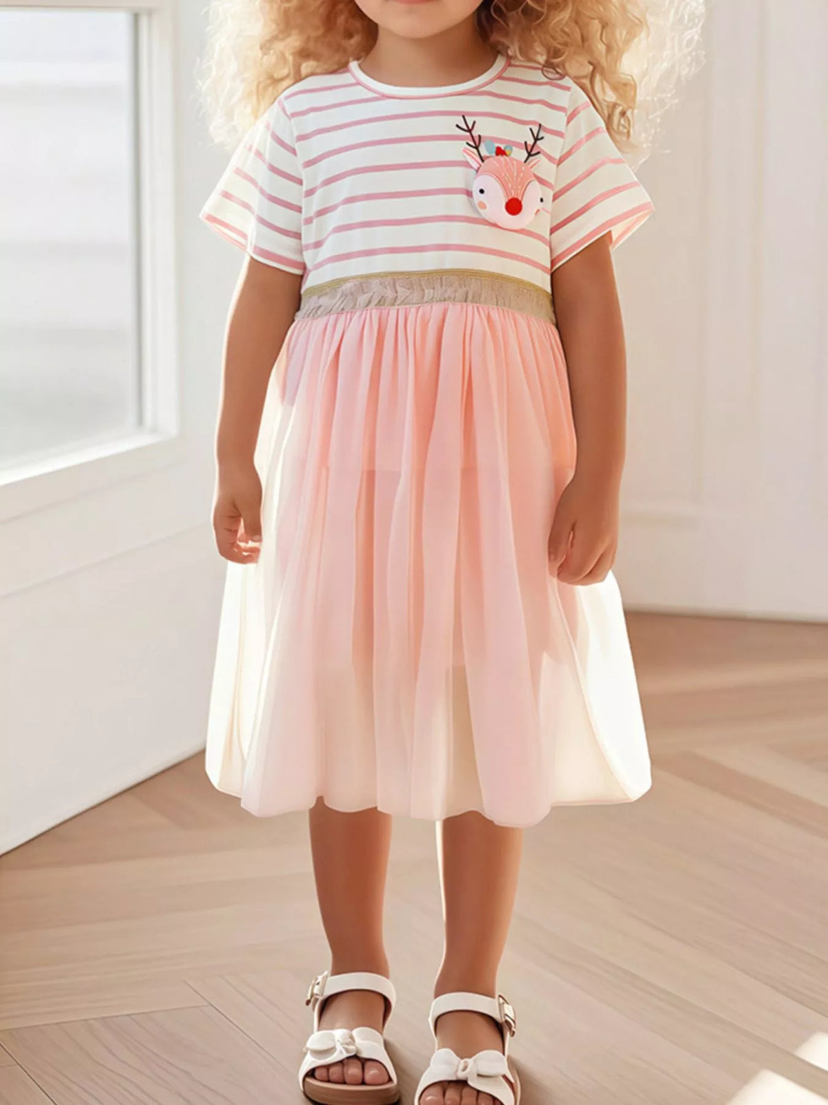 Pink striped reindeer dress with a pink tulle skirt on a child