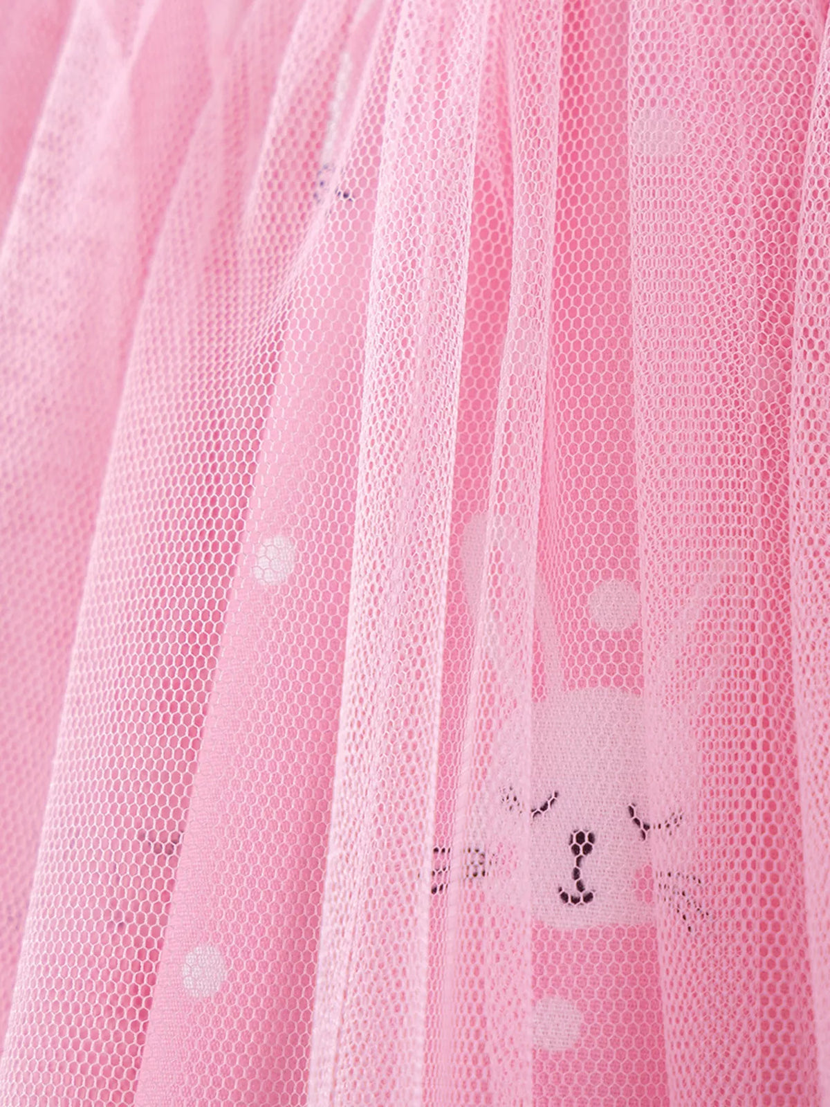 Bunny and dot motifs beneath the pink tulle overlay