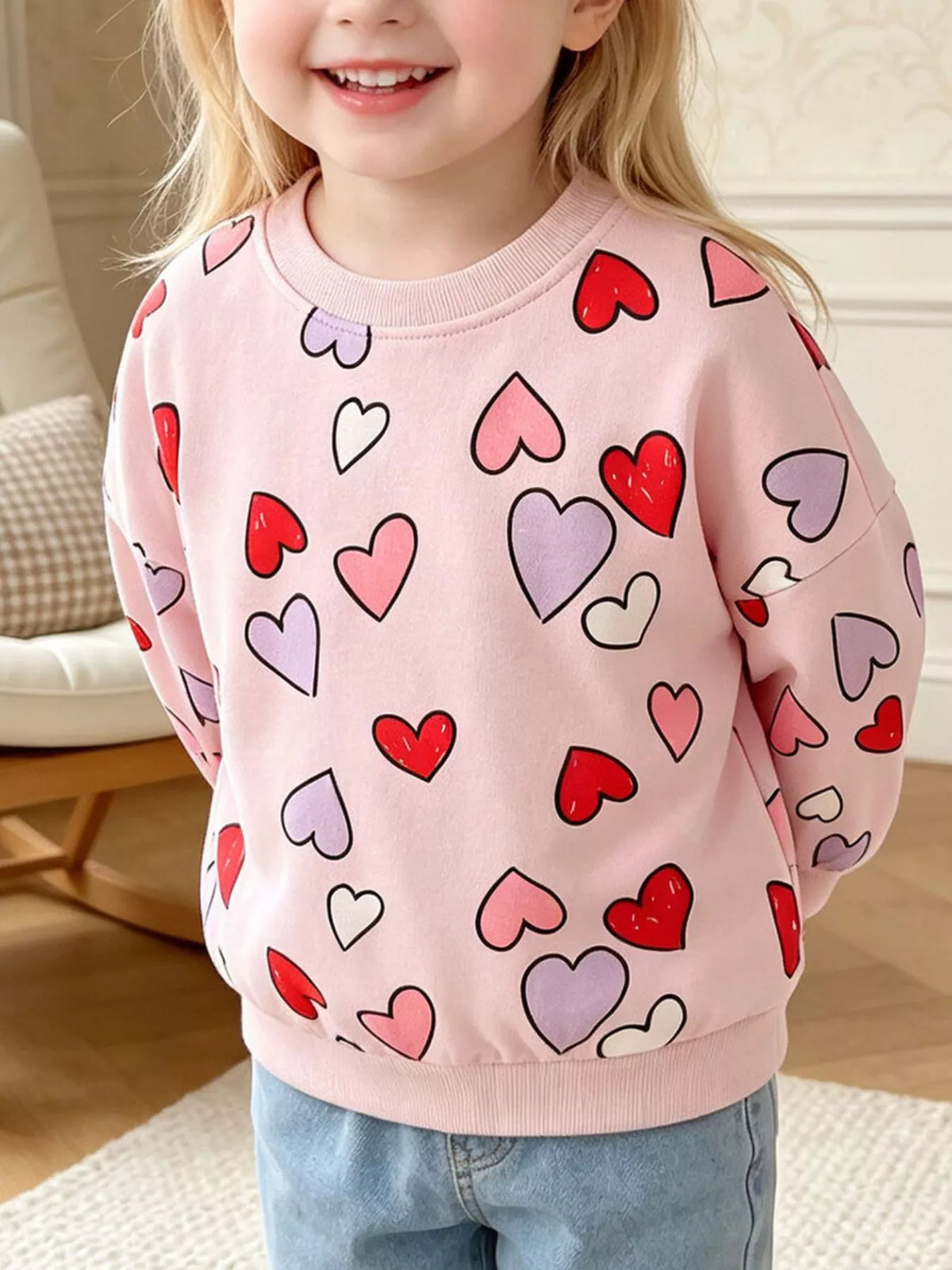 Pink multicolored-heart crewneck sweatshirt on a child