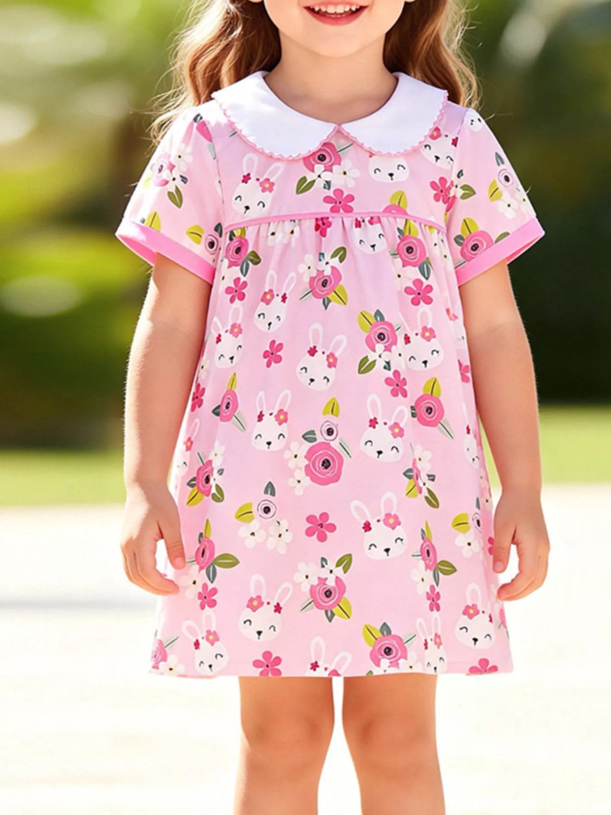 Pink bunny-and-flower dress with a white Peter Pan collar on a child