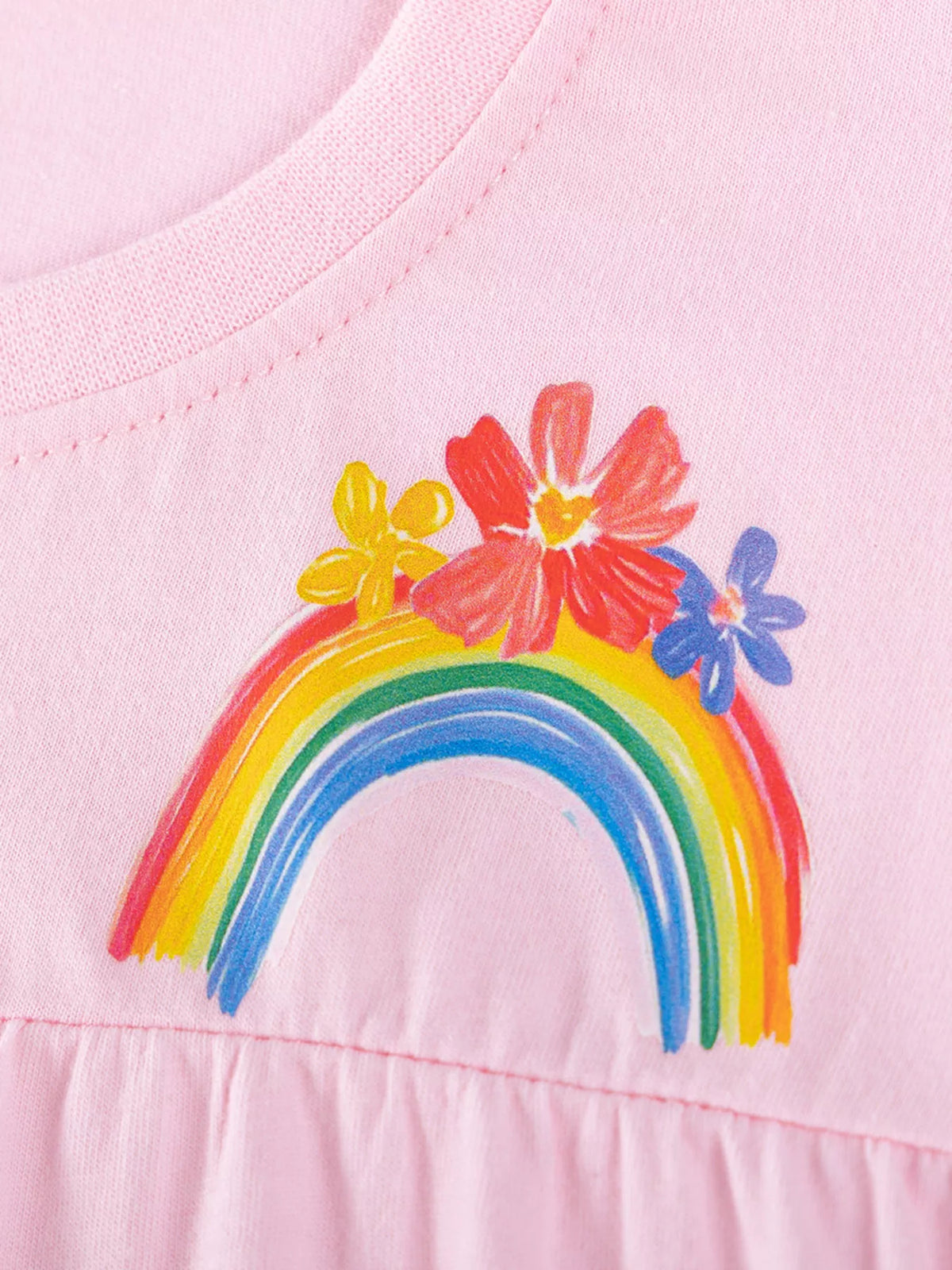 Rainbow and flower motif above the gathered waist