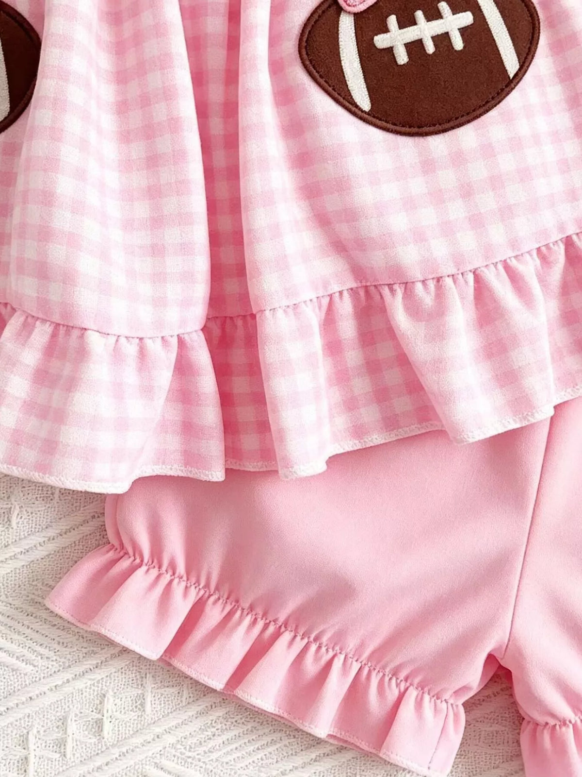 Ruffled top hem above the pink shorts