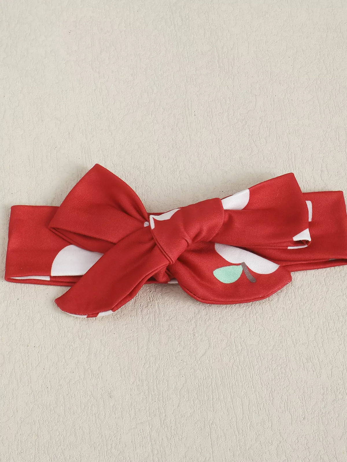 White ribbed apple bodysuit red flare pants and headband — matching bow headband