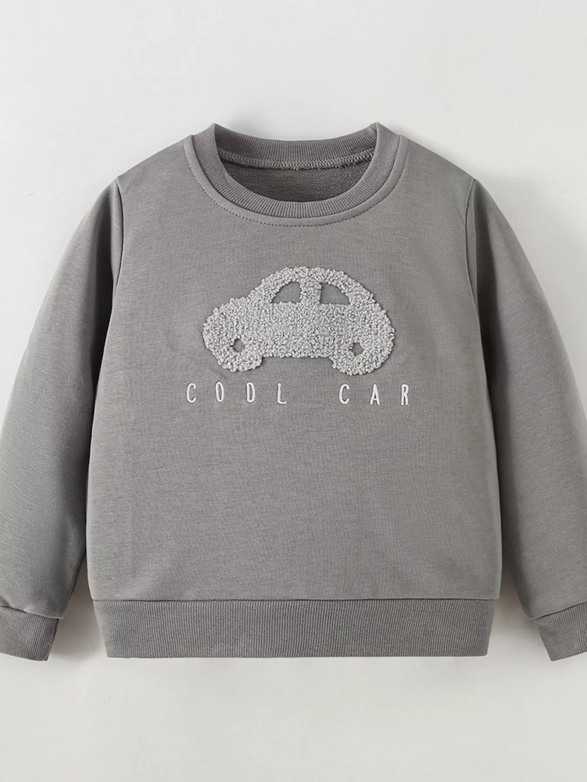 Gray crewneck sweatshirt with a textured car applique laid flat
