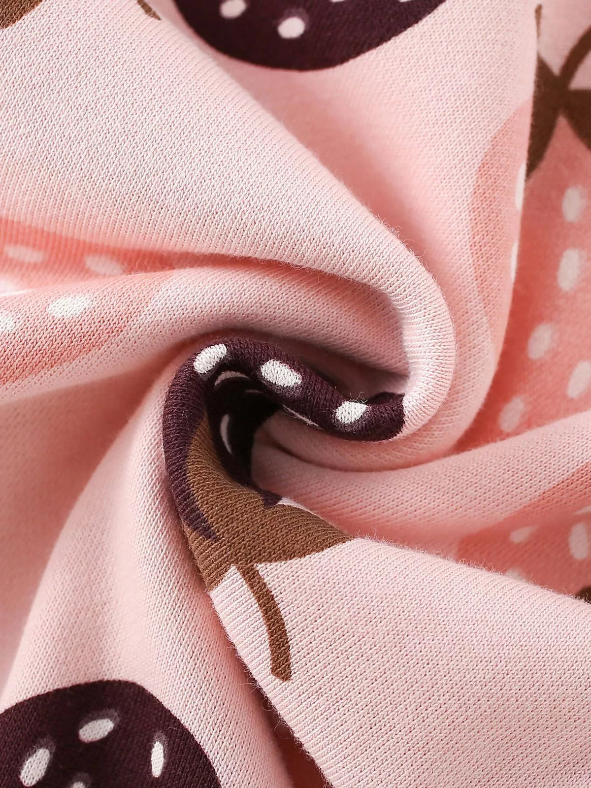 Pink strawberry-print fabric close-up