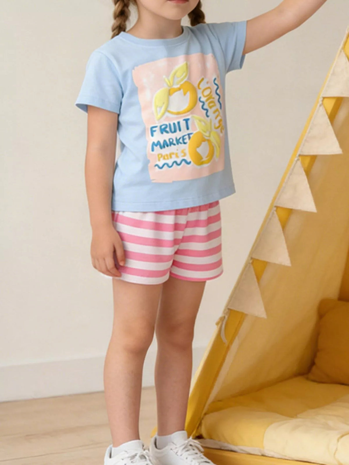 Blue Fruit Market graphic tee and pink striped shorts — outfit shown on child
