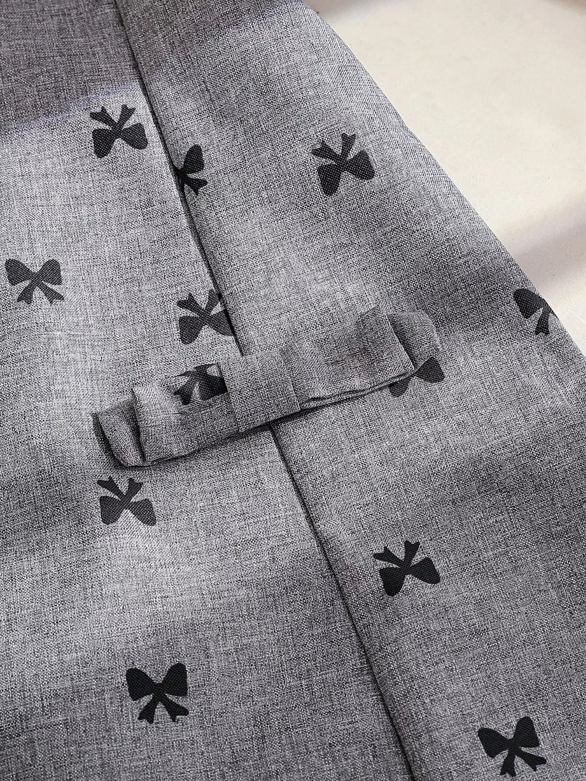 Bow-print fabric and decorative pocket flap