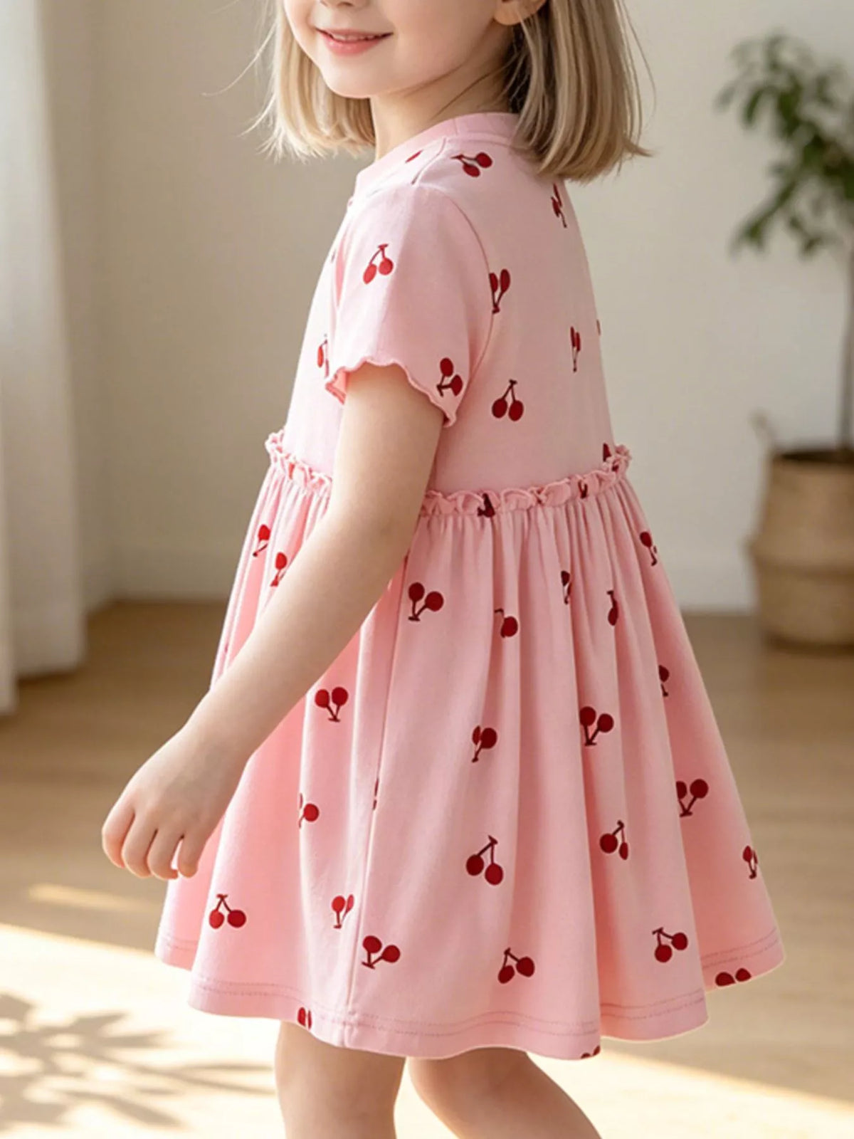 Side view of the cherry dress on a child