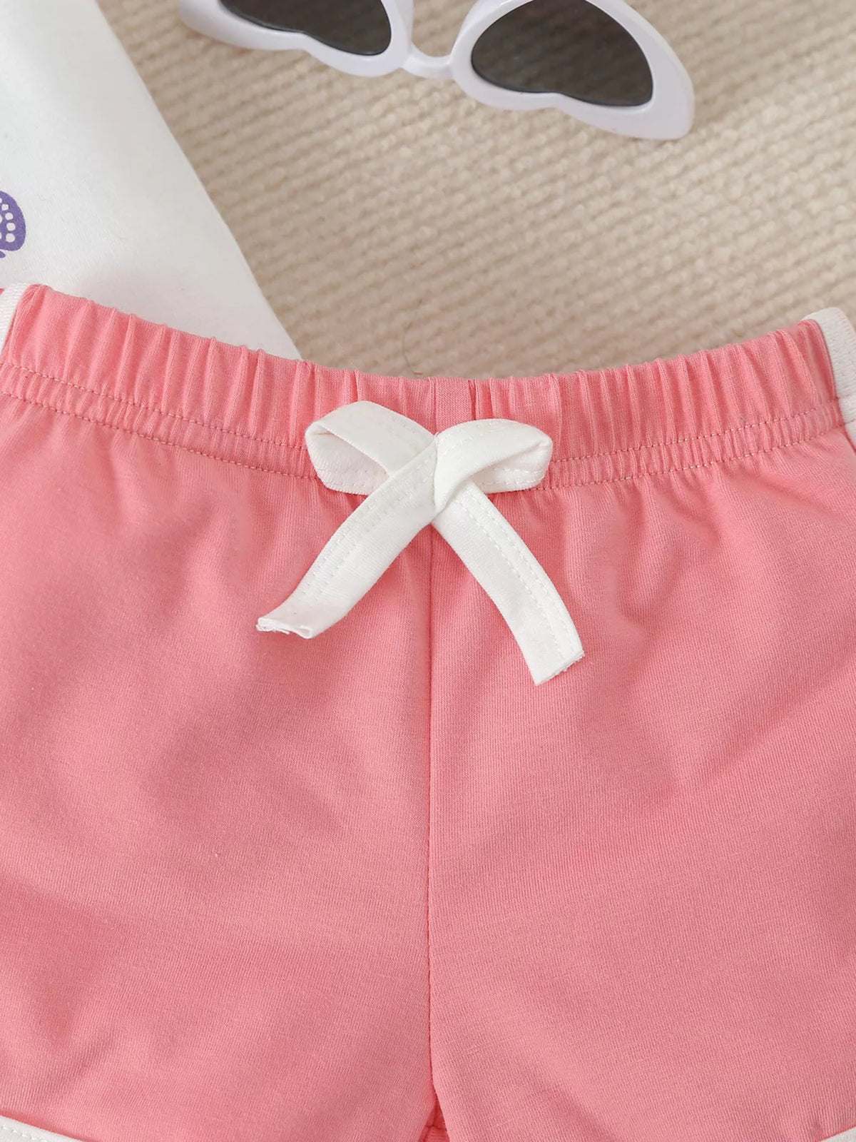 White bow drawstring at the pink waistband