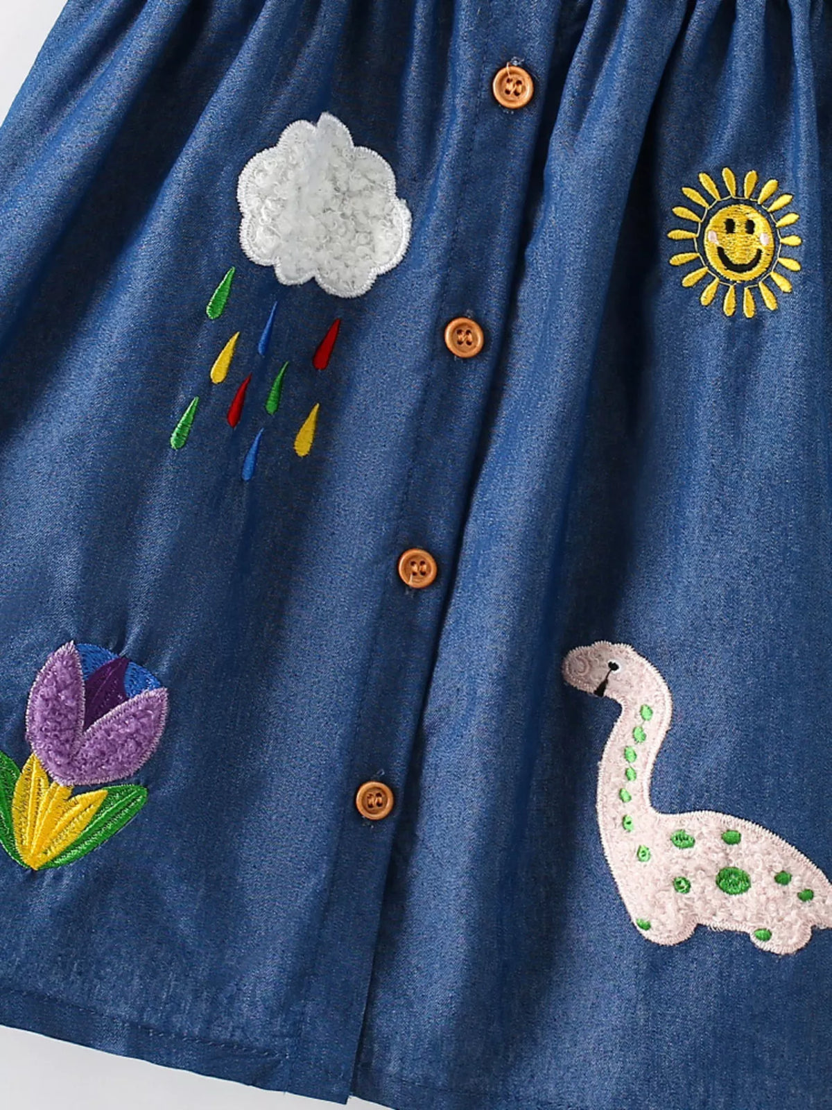 Dark Denim Dinosaur Embroidered Dress — dinosaur cloud sun and flower embroidery