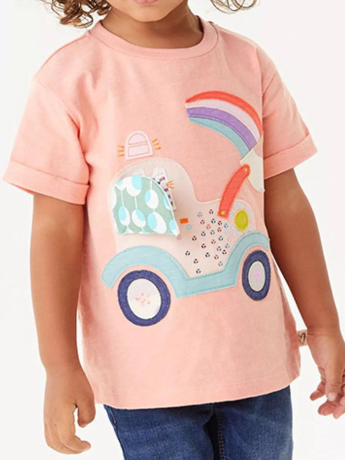 Peach rainbow vehicle applique shirt — shirt shown on child