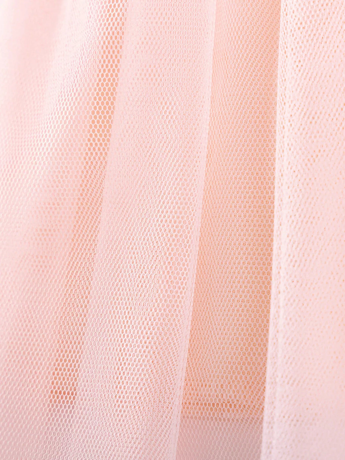 Layers of peach tulle at the skirt