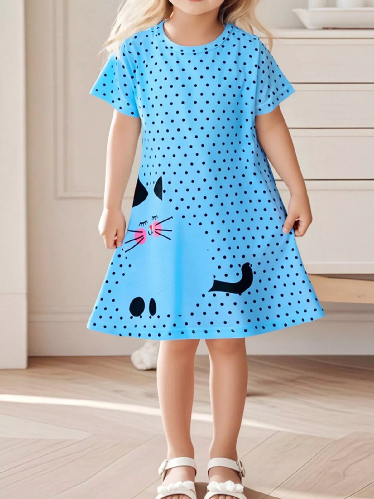 Blue polka-dot short-sleeve cat dress on a child