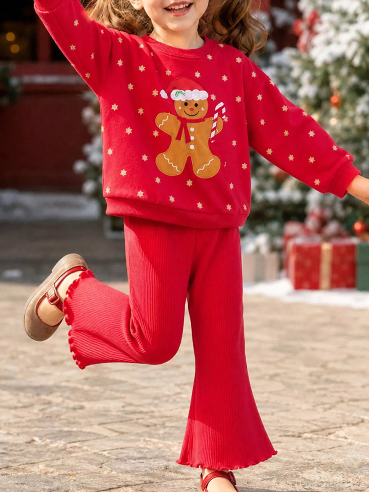 Red gingerbread sweatshirt with red flared pants on a child