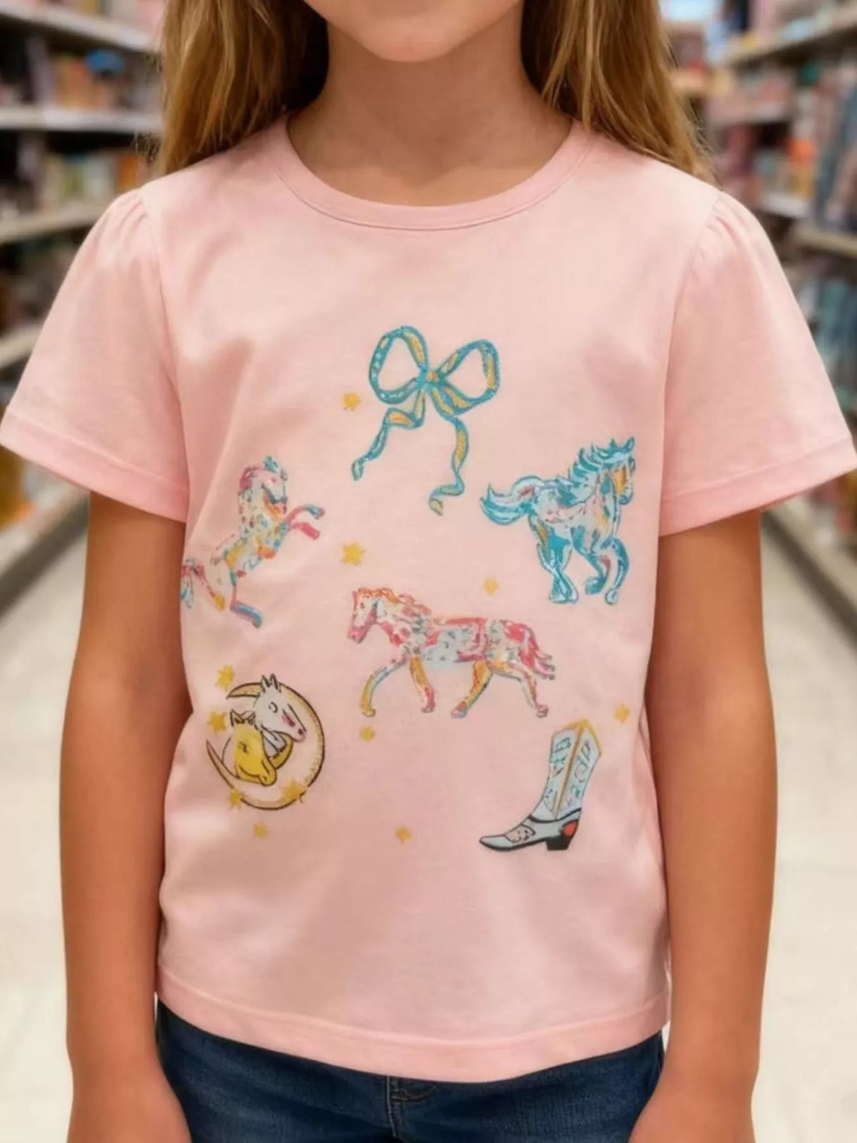 Peach horse bow and boot graphic shirt — shirt shown on child