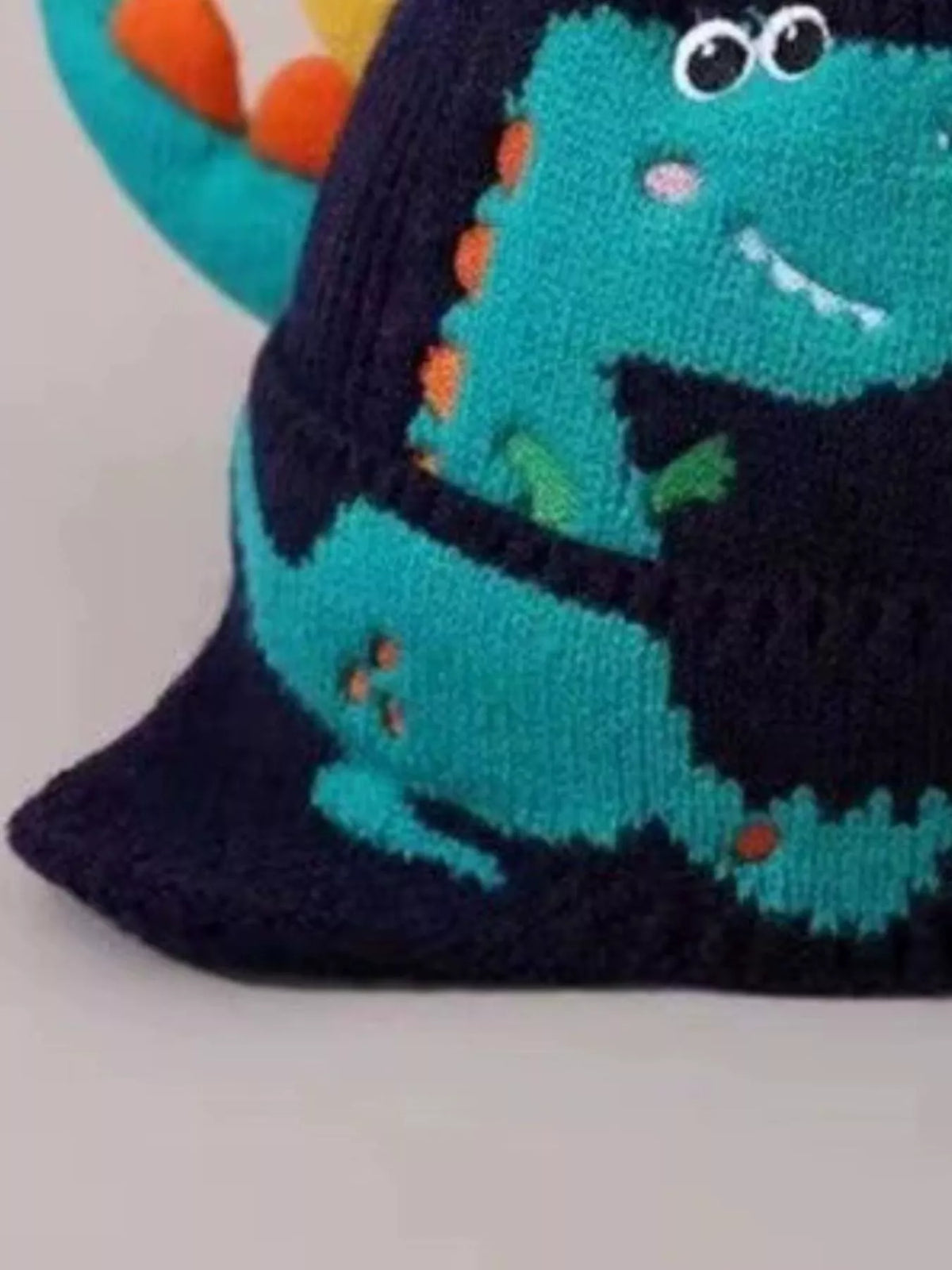 Dinosaur Knit Hat with Earflaps — navy hat dinosaur detail