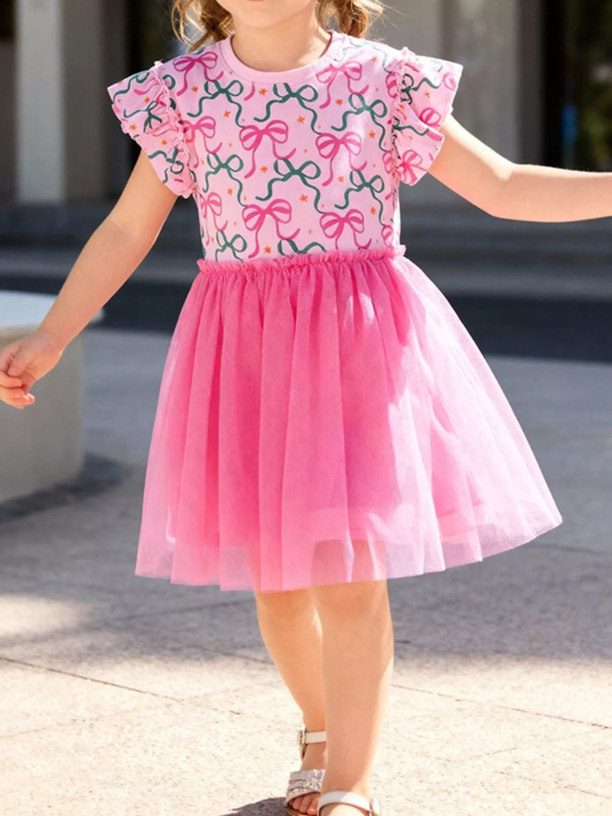 Pink bow-print ruffle-sleeve dress with a bright tulle skirt on a child
