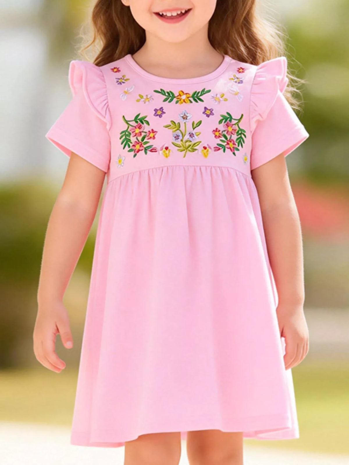 Pink floral-embroidered dress with shoulder ruffles on a child