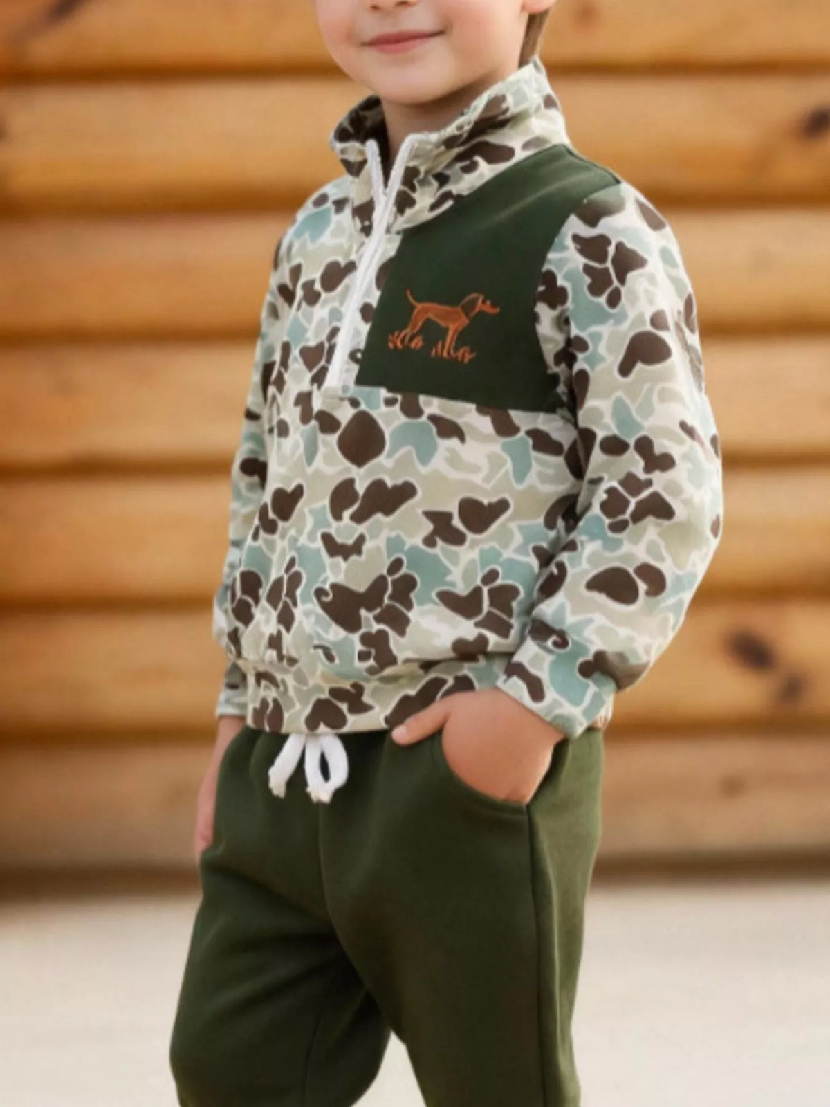 Green quarter-zip top and drawstring waist on a child