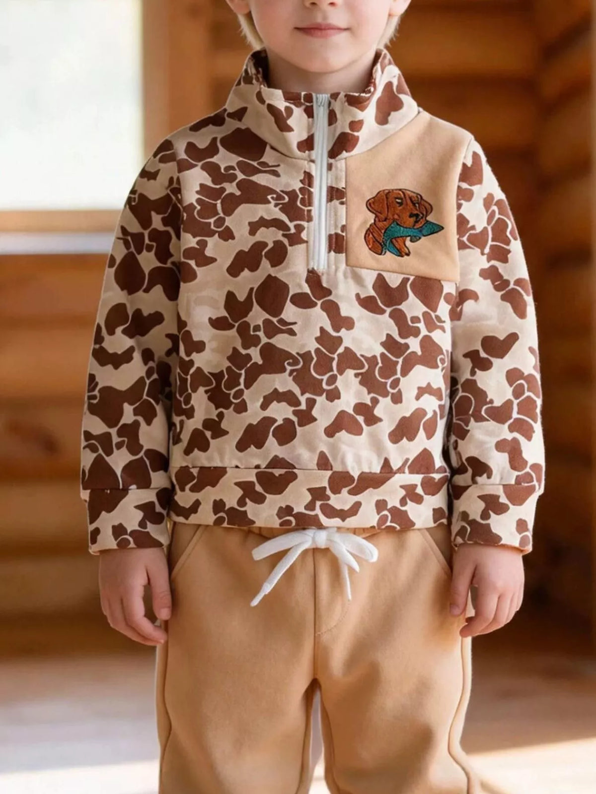 Brown camouflage top and tan joggers on a child