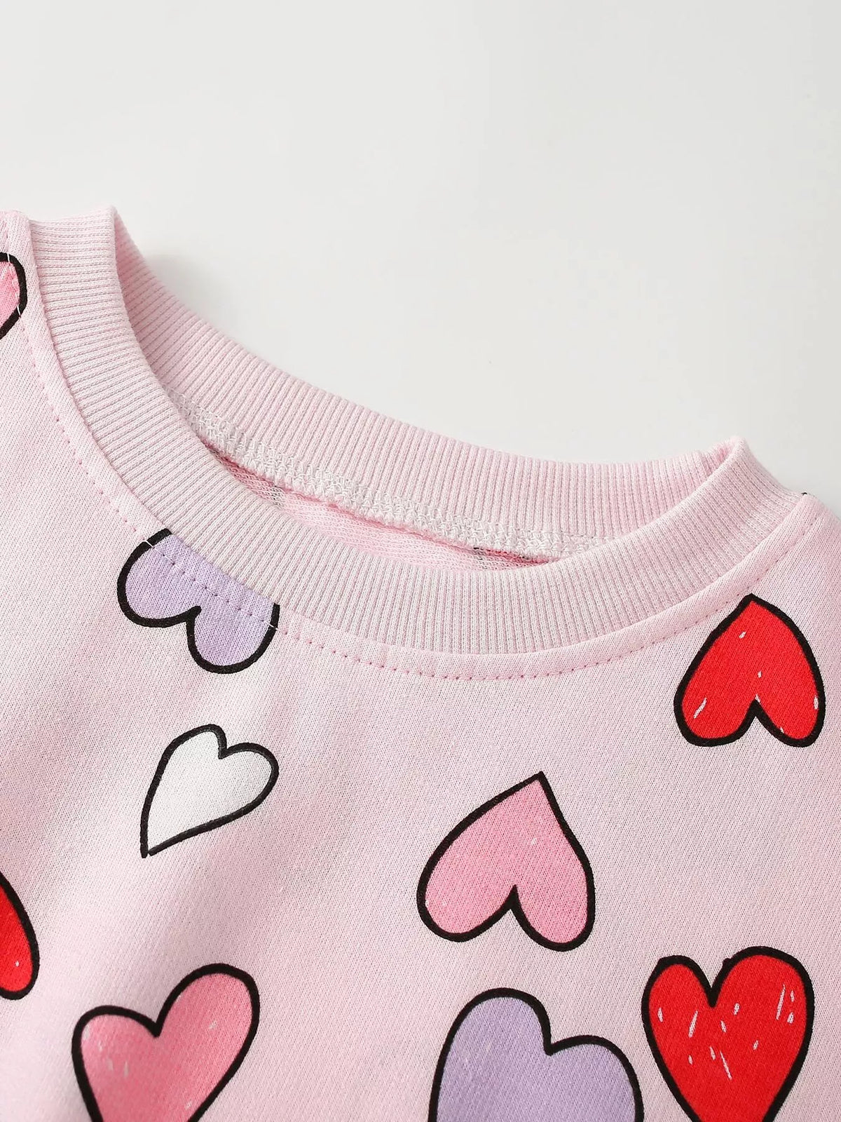 Pink round neckline and heart motifs
