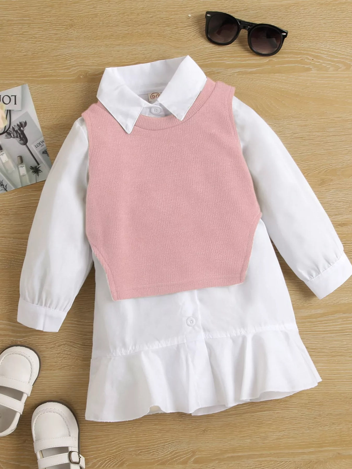 White ruffle-hem shirt dress styled with a pink knit vest laid flat