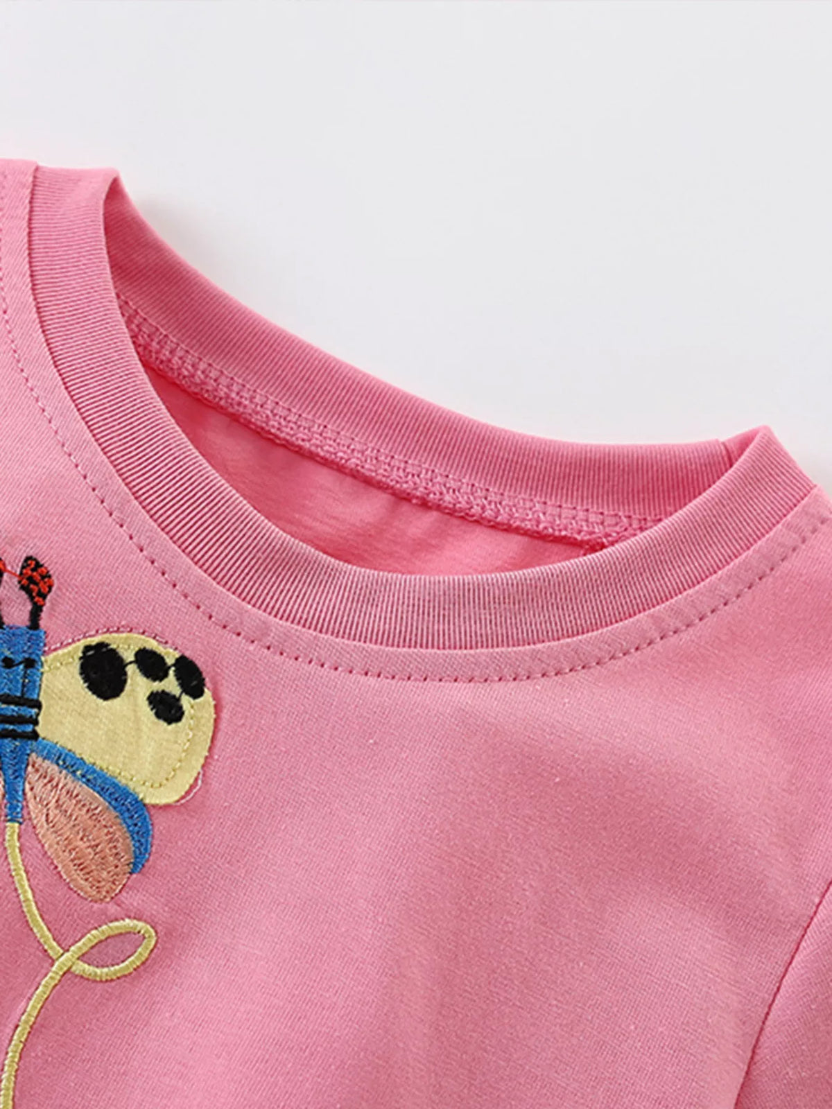 Pink lion and butterfly applique shirt — round neckline